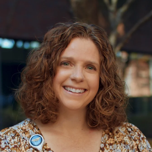 Image of a woman with curly hair smiling